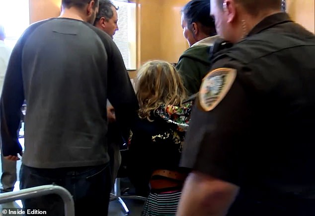 The girl, whose name has been withheld due to her age, was charged with felony first-degree intentional homicide as an adult. She is seen from behind during a court hearing