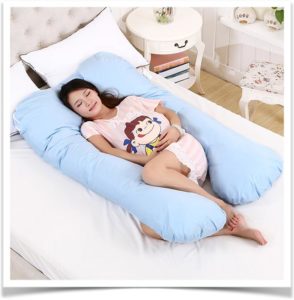 Беременная спит на спите в большой подушке