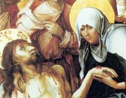 Mary, an older woman wearing a full white headscarf and depicted with a halo of light around her head, holds the hand of the dying Jesus and weeps