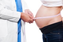 a doctor measuring a pregnant woman